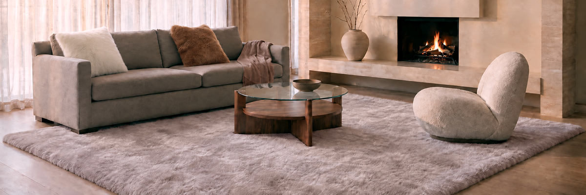 Refined living room with a light gray baby alpaca fur rug and chestnut alpaca fur cushion beside a fireplace