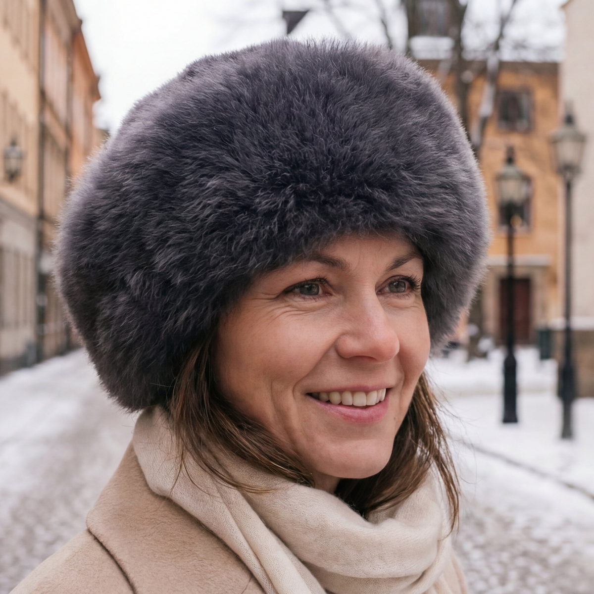 Woman wearing a charcoal baby alpaca fur hat in a snowy urban setting