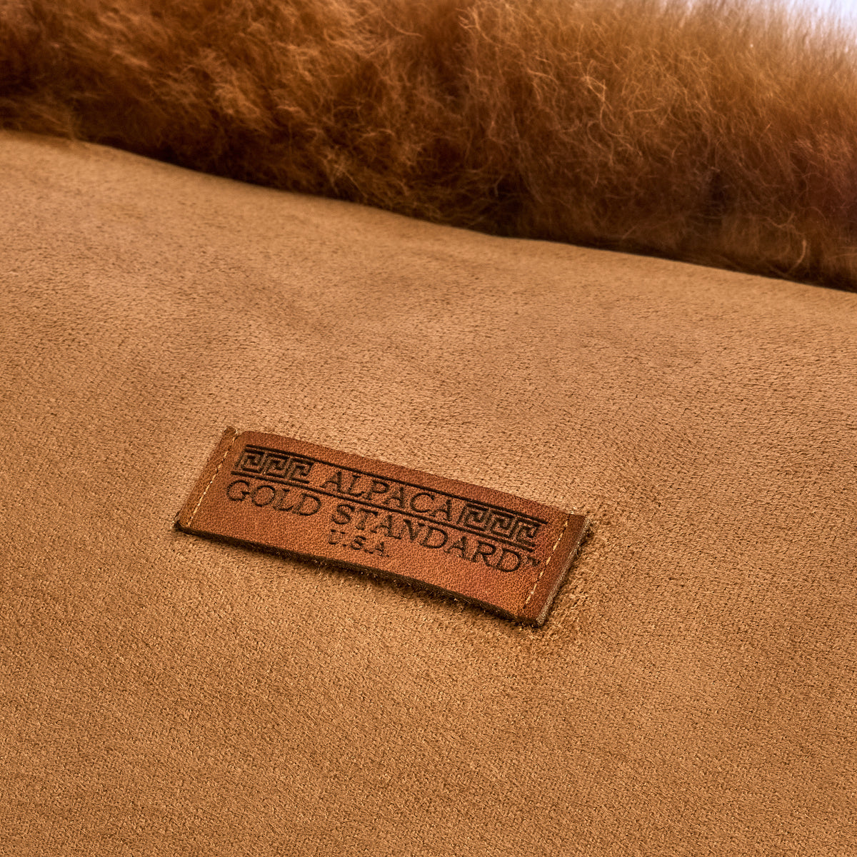 Back of chestnut baby alpaca fur cushion with Alpaca Gold Standard label
