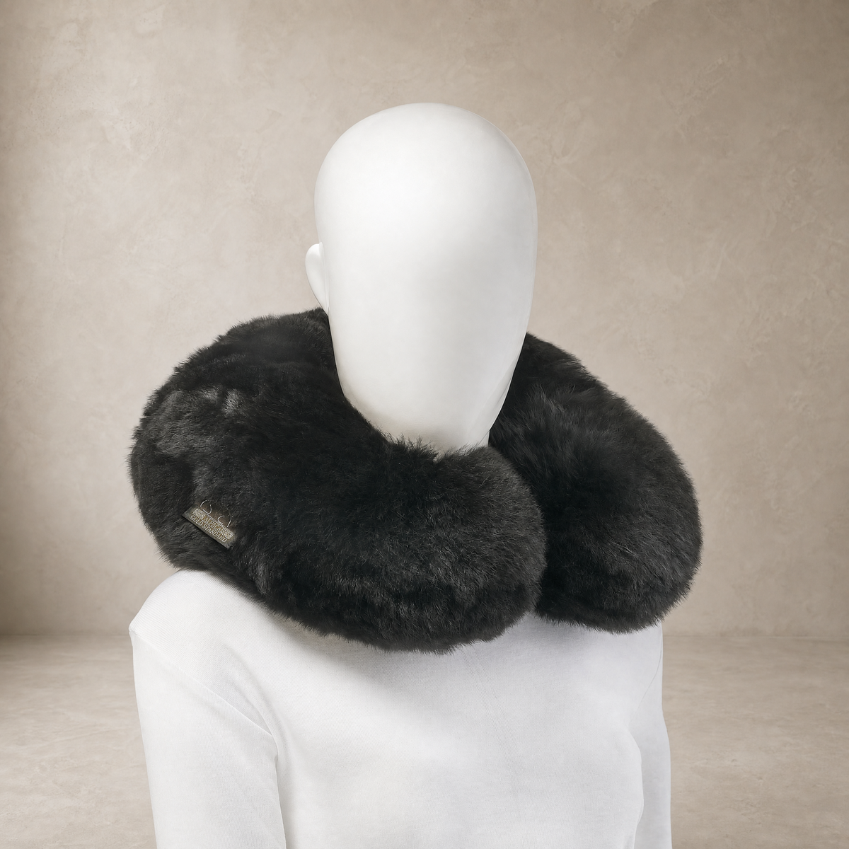 Black baby alpaca fur neck pillow with Alpaca Gold Standard label