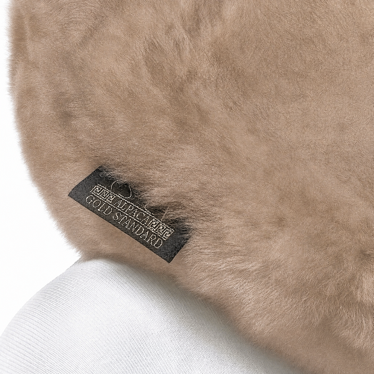 Soft taupe baby alpaca fur neck pillow worn around the neck