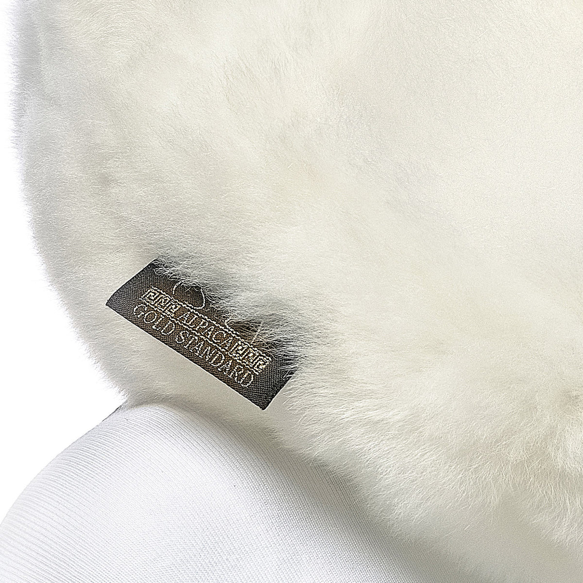 Ivory white baby alpaca fur neck pillow with Alpaca Gold Standard label