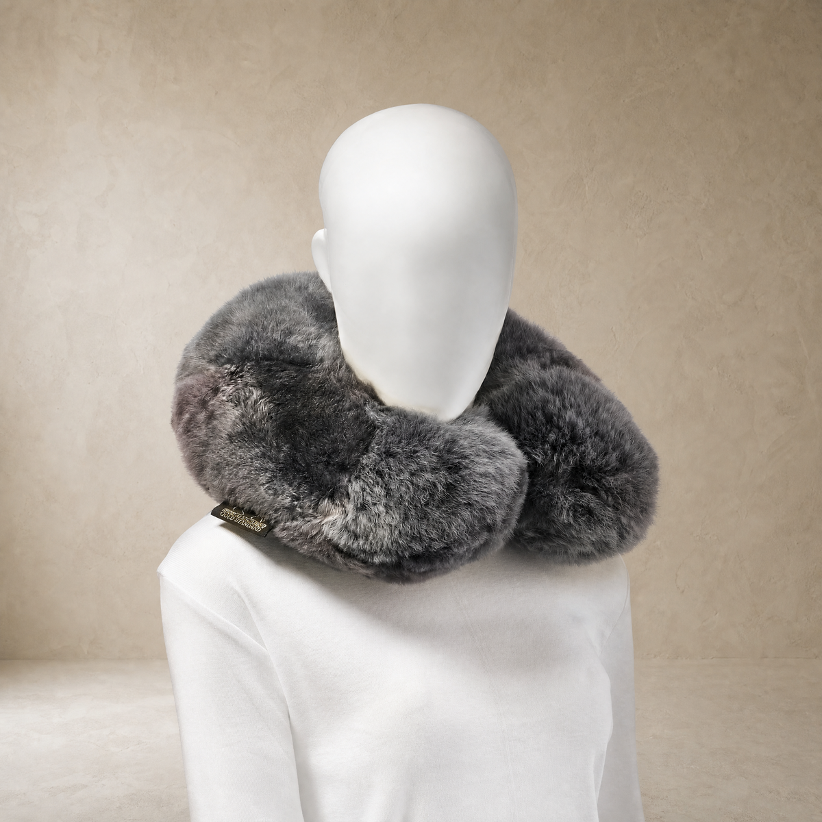 Soft dark gray baby alpaca fur neck pillow worn around the neck
