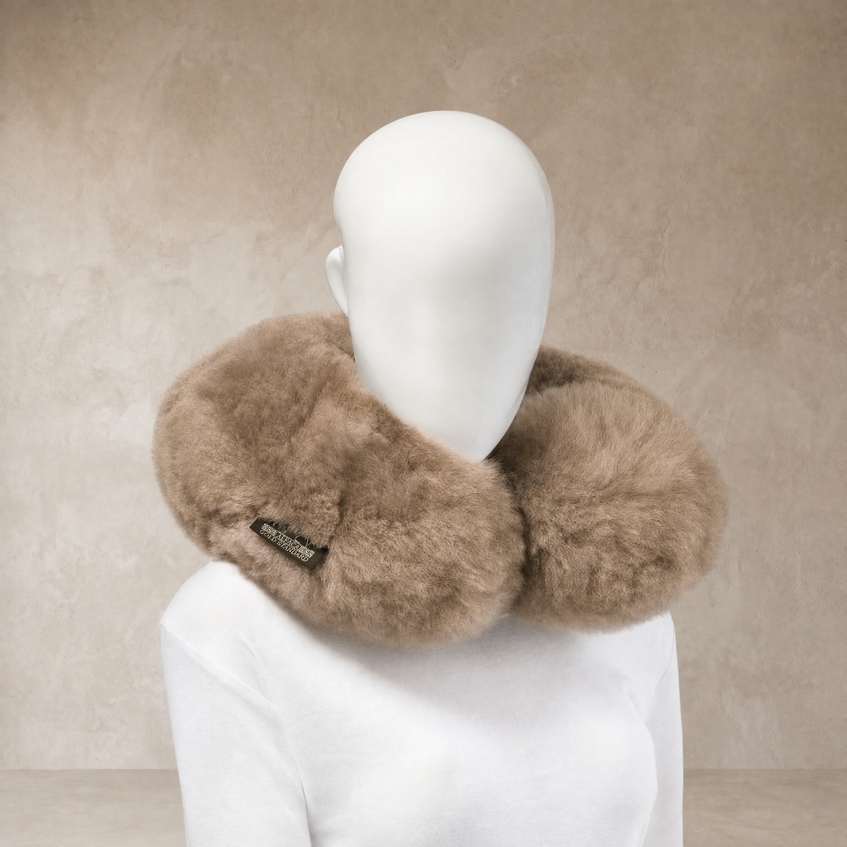 Soft taupe baby alpaca fur neck pillow worn around the neck