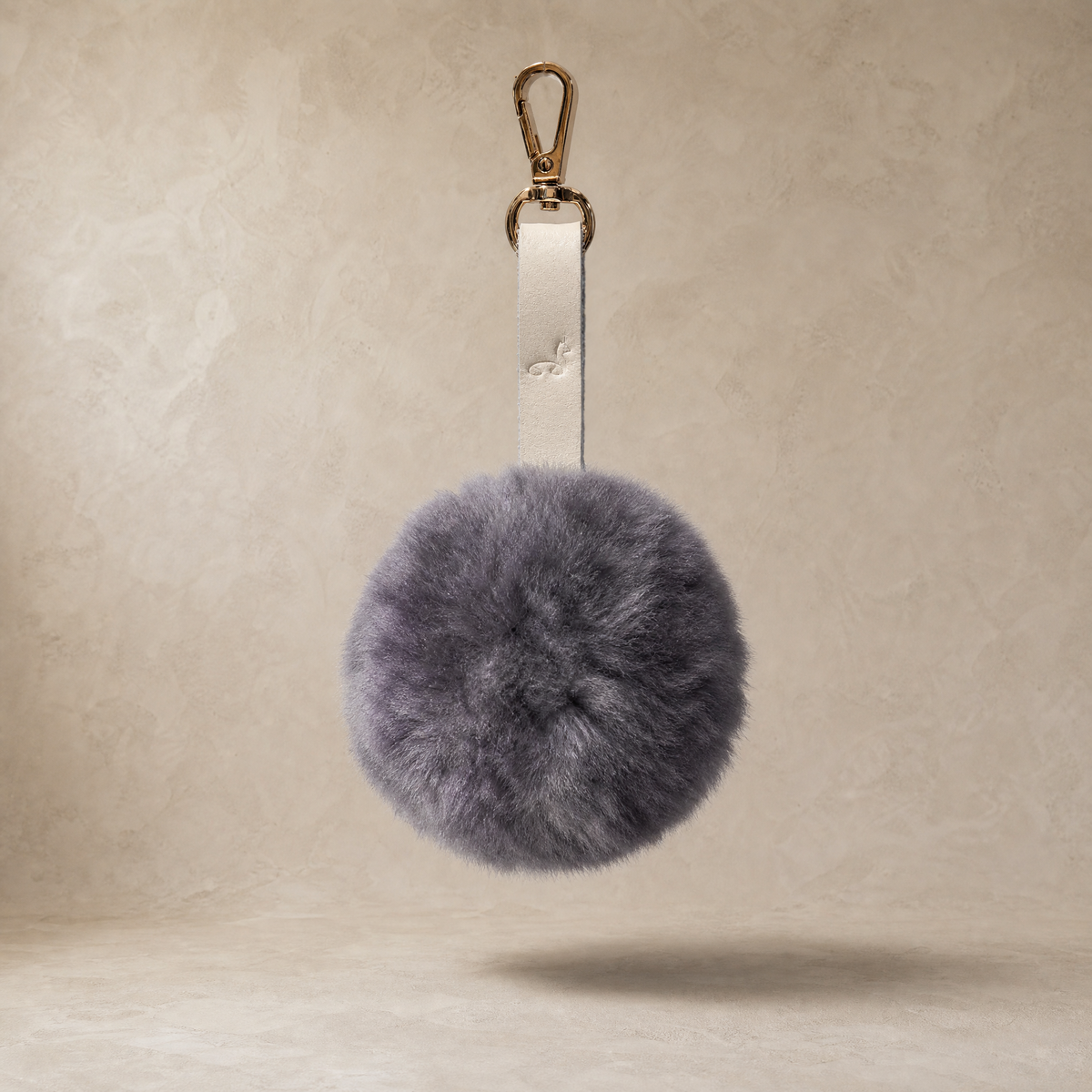 Dark gray soft baby alpaca fur pompon with leather strap and golden lobster clasp