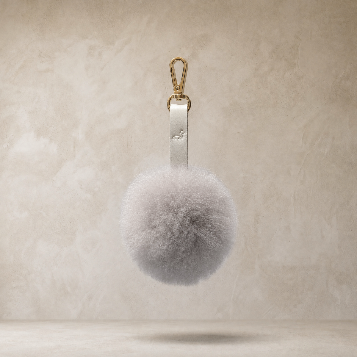 LIght gray soft baby alpaca fur pompon with leather strap and golden lobster clasp