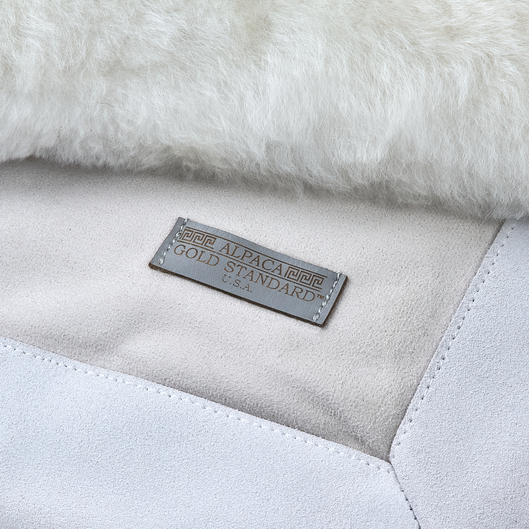 Back of ivory white baby alpaca fur rug with Alpaca Gold Standard label
