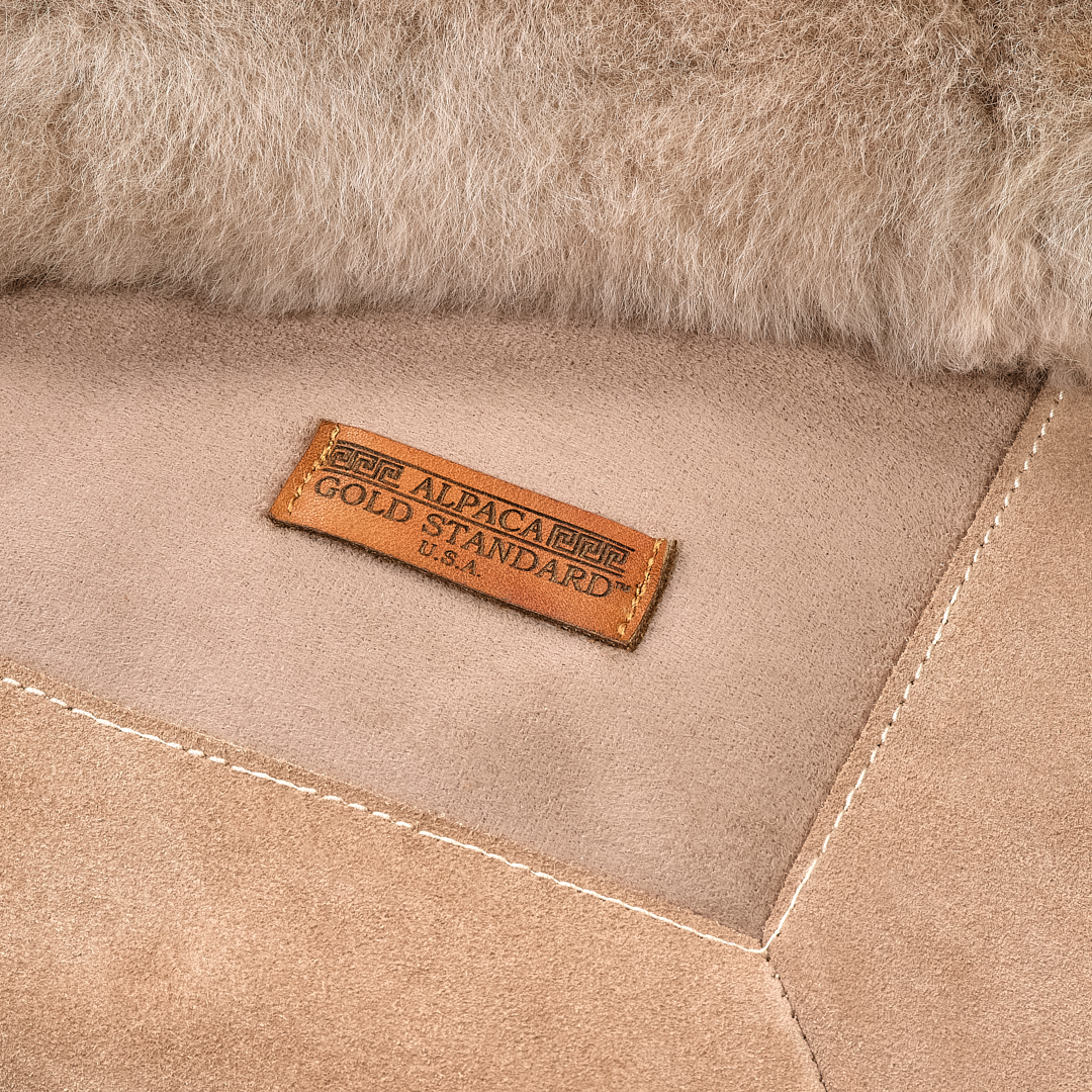 Back of taupe baby alpaca fur rug with Alpaca Gold Standard label