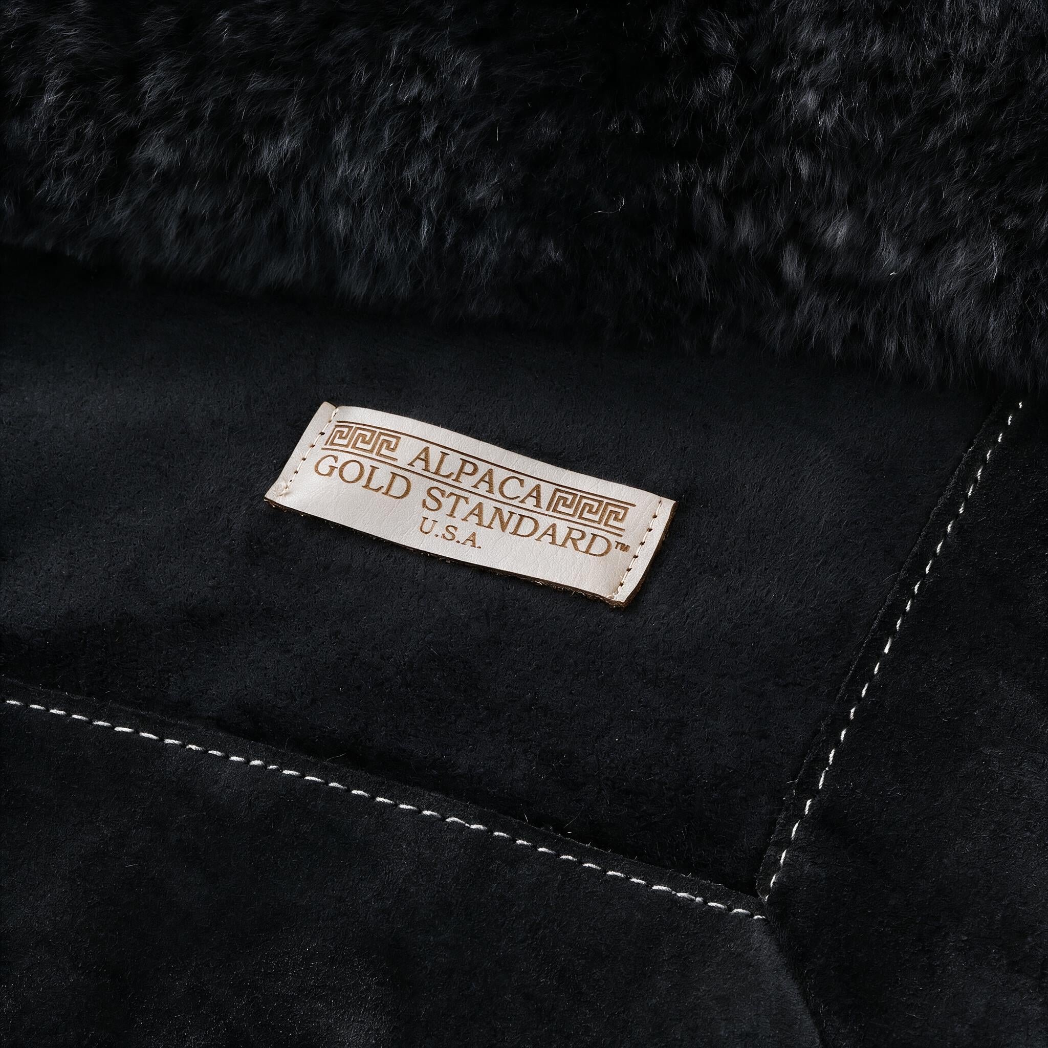Back of black baby alpaca fur rug with Alpaca Gold Standard label