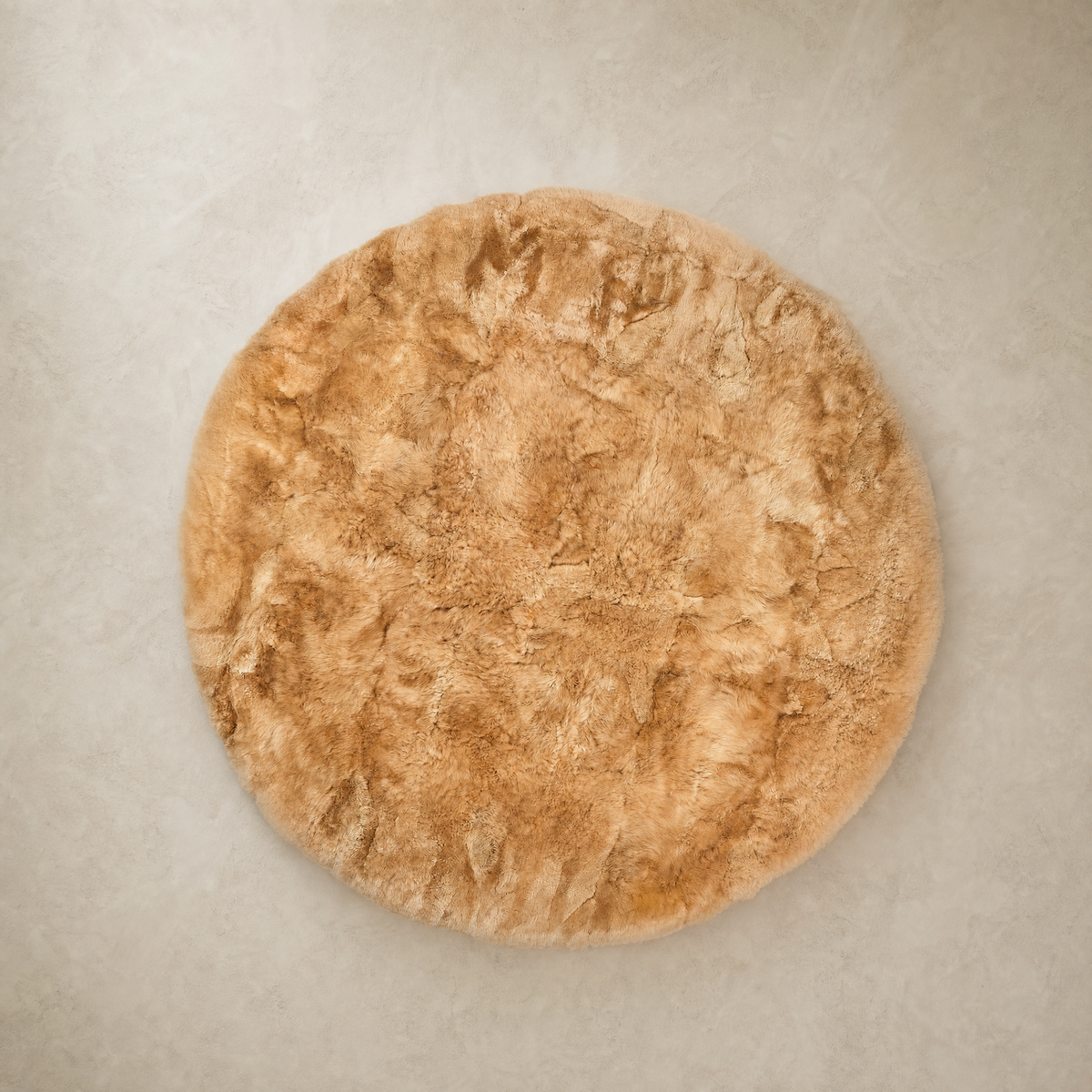 Beige round baby alpaca fur area rug