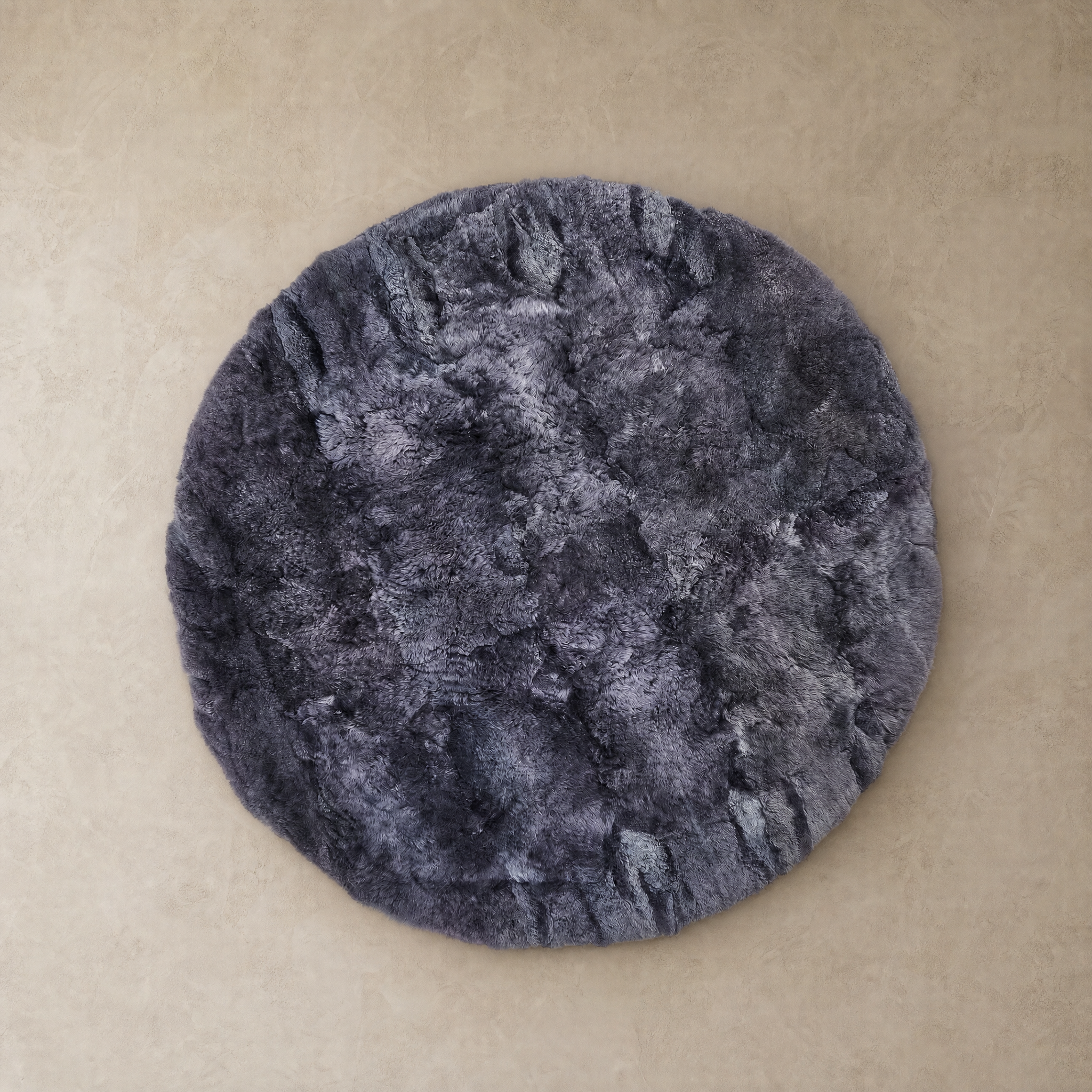 Dark gray round baby alpaca fur area rug