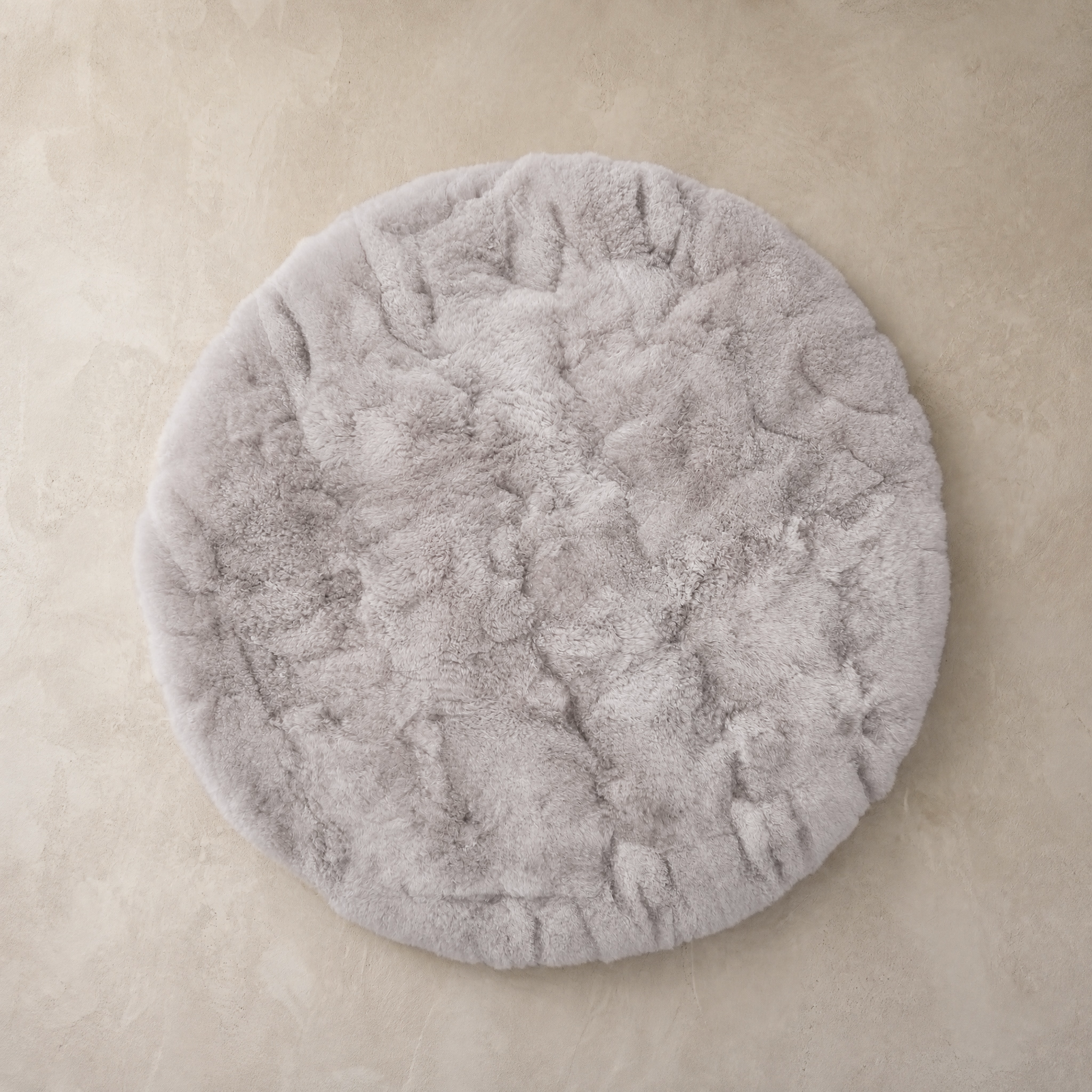 Light gray round baby alpaca fur area rug