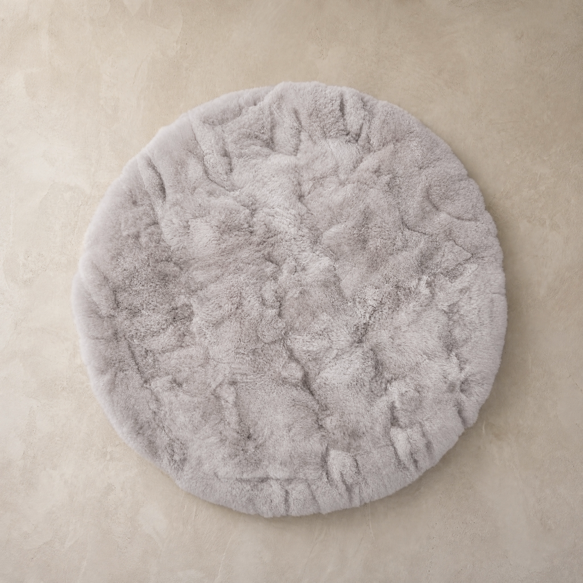 Light gray round baby alpaca fur area rug