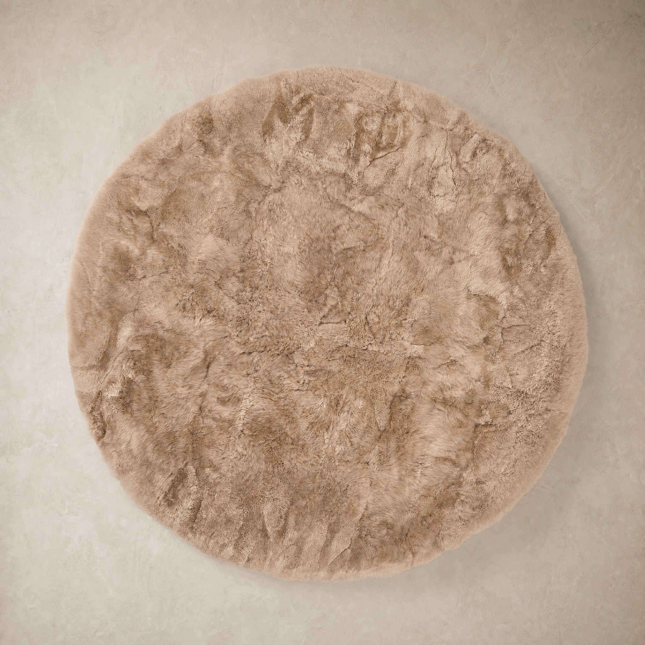 Taupe round baby alpaca fur area rug