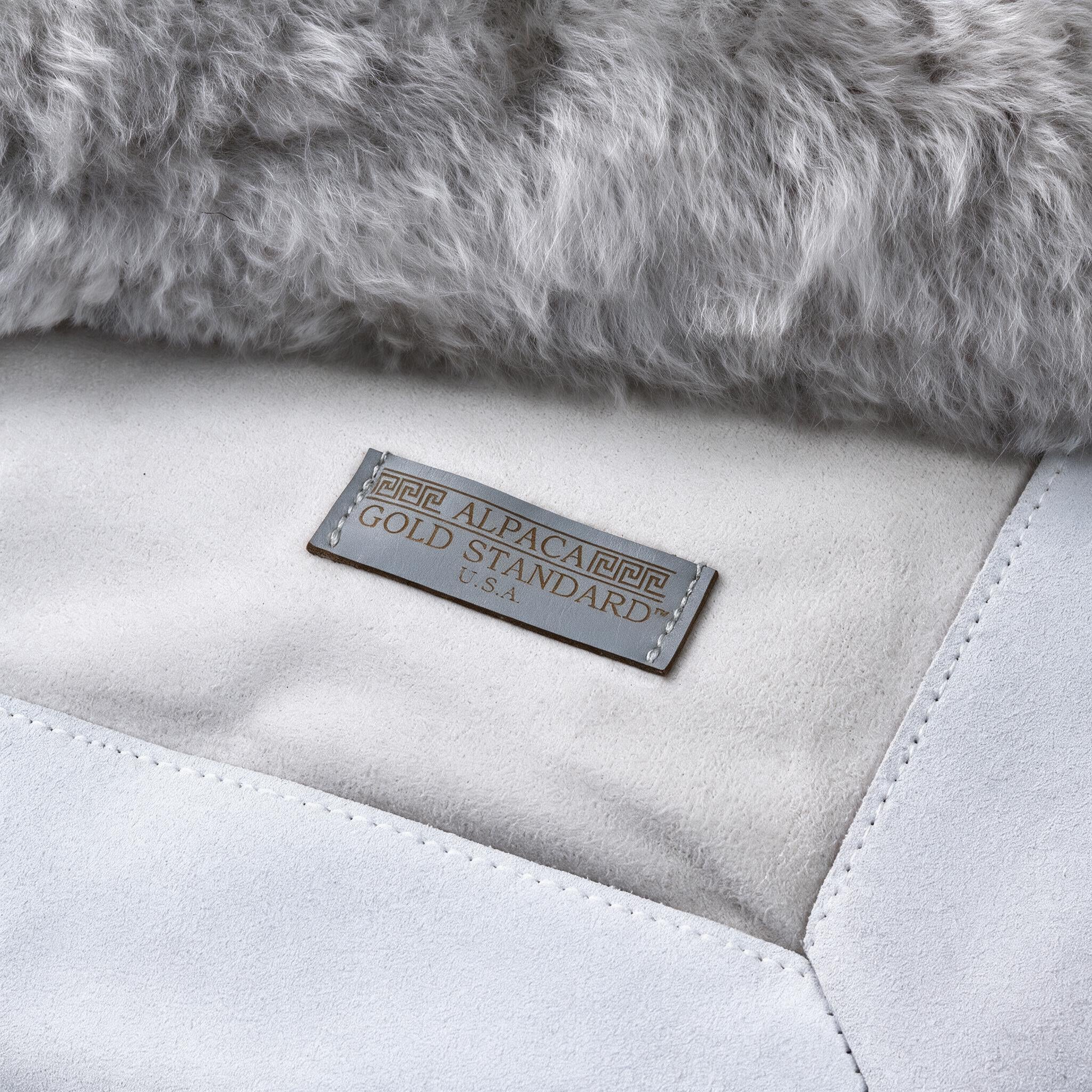 Back of light gray baby alpaca fur rug with Alpaca Gold Standard label