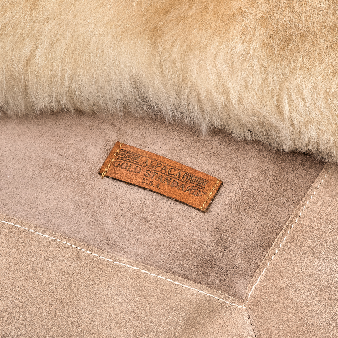Back of beige baby alpaca fur rug with Alpaca Gold Standard label