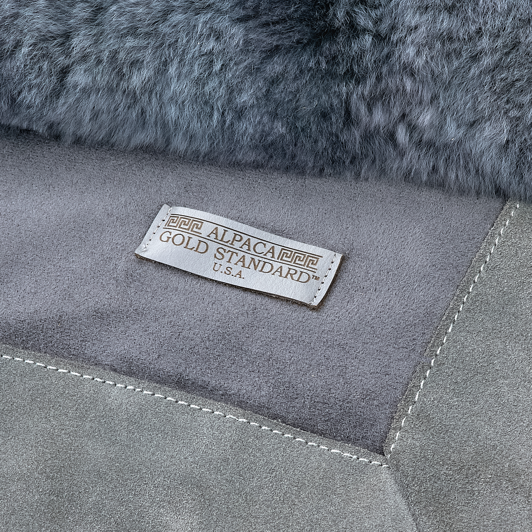 Back of dark gray baby alpaca fur rug with Alpaca Gold Standard label